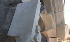 New stones are pinned carefully into the stone wall New stones are pinned carefully into the stone wall