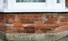 Carved and installed red rubber bricks