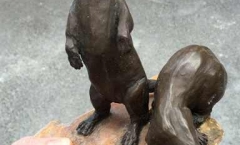 Restored resin and plaster otter sculpture - glued tail, feet and paws 